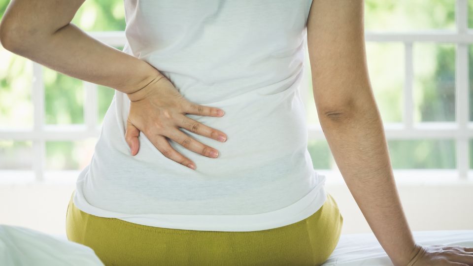 Woman Suffering From Lower Back Pain From Sitting Too Long