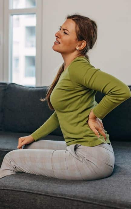A Woman Experiencing Back Pain In Hinsdale, IL
